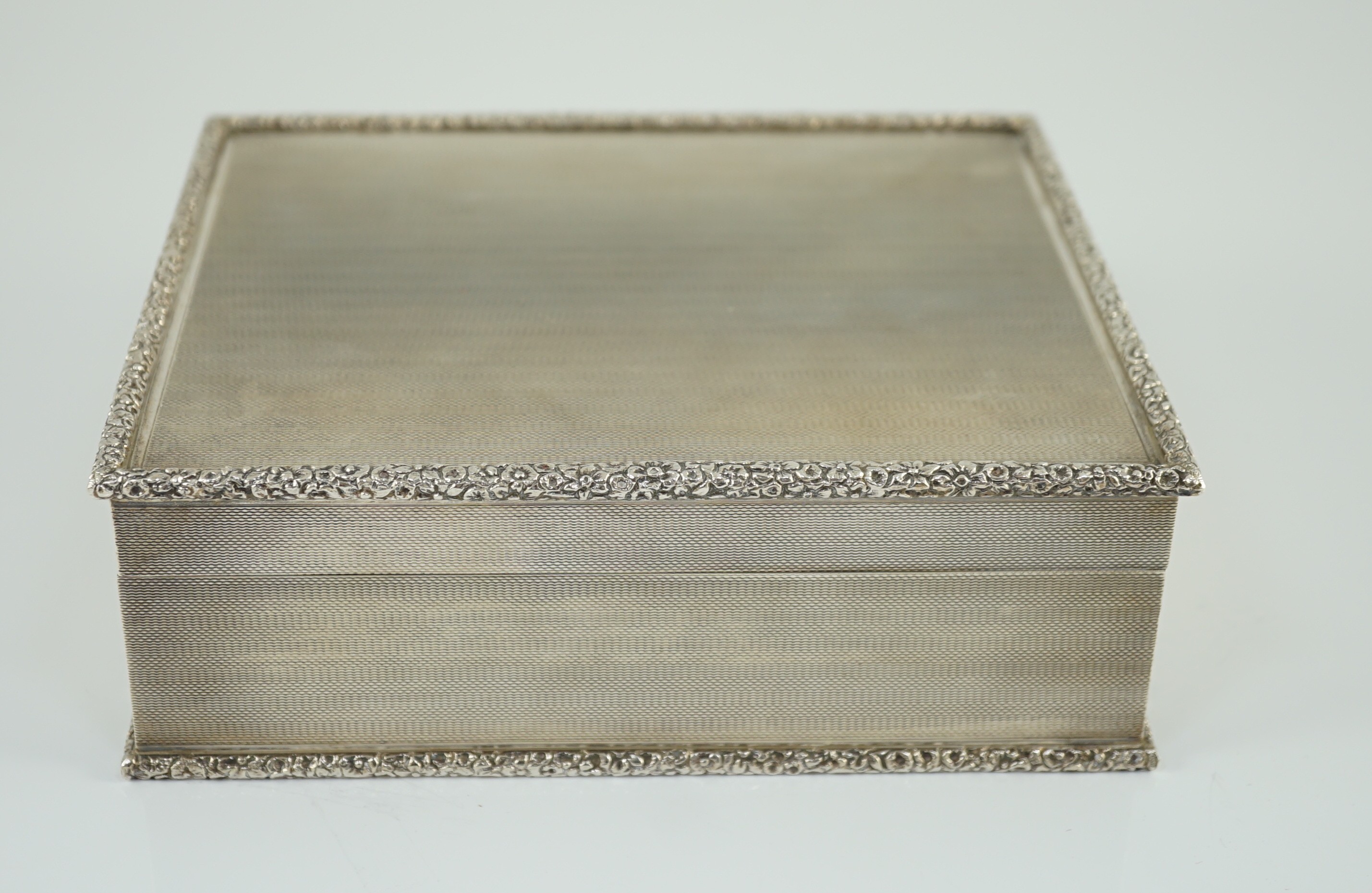 An Elizabeth II engine turned silver rectangular cigar box, by S.J. Rose & Son